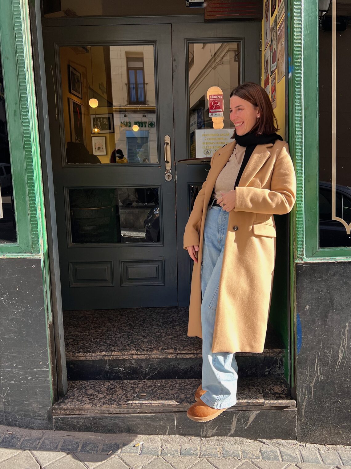 Nicole Pyzyk standing outside a café, smiling in the morning light — representing calm energy and focus from her morning reset routine.